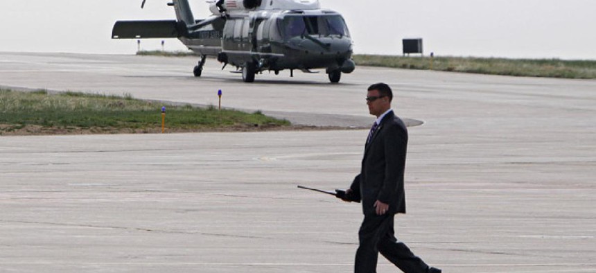 A Secret Service Agents walks the tarmac as Marine One carrying President Barack Obama taxis. 