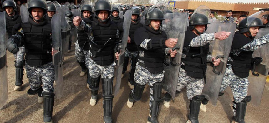 Iraqi police march during a graduation ceremony.