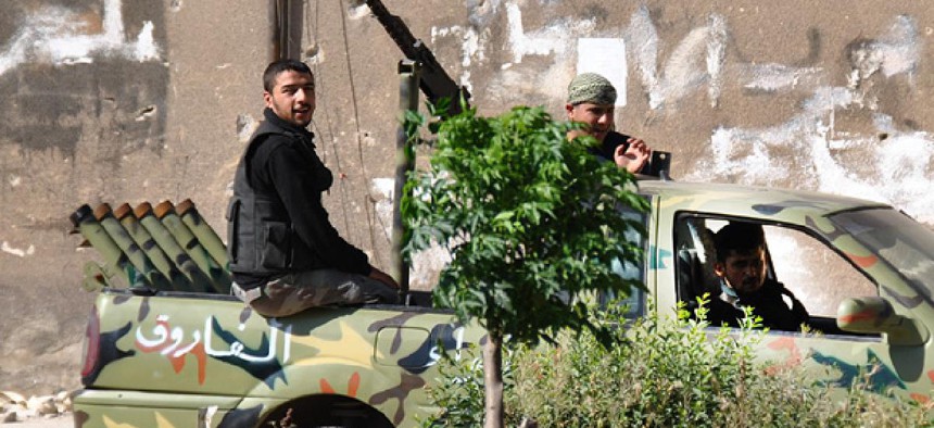 Syrian rebels patrol Khaldiyeh neighborhood, in Homs province.
