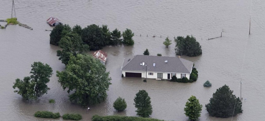 A home is engulfed by flood water in Hamburg, Iowa from the rising Missouri River in 2011.  