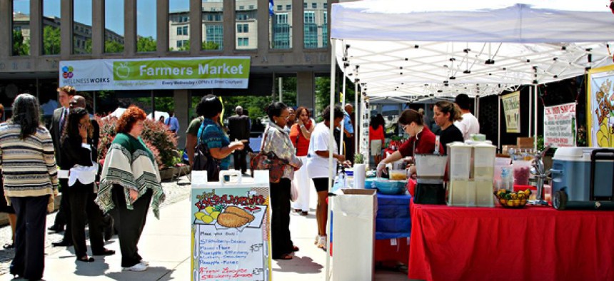 People line up at the fresh smoothie stand during the opening day of the market last May.