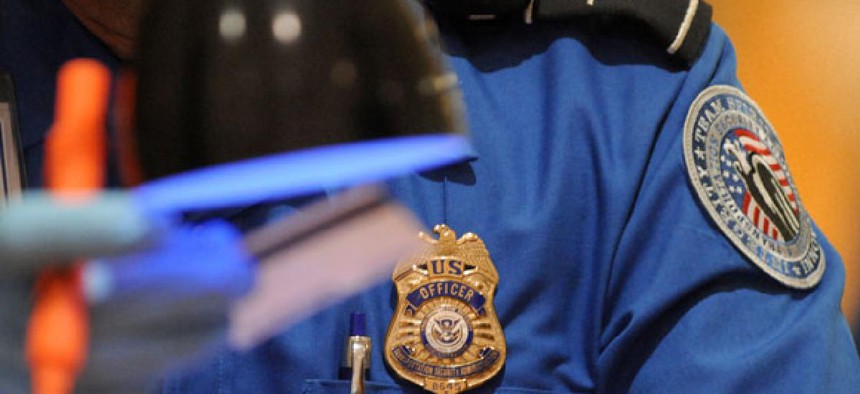 A TSA officer checks ID at Hartsfield-Jackson Atlanta International Airport in 2011.