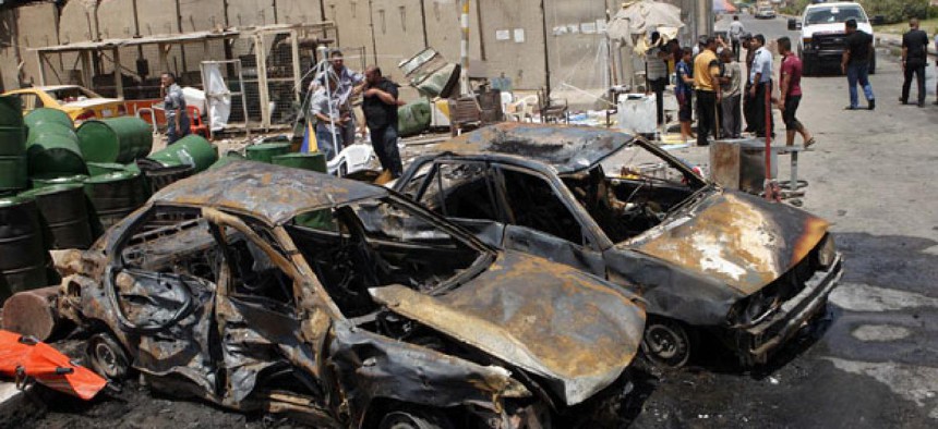 Iraqis inspect the aftermath of a car bomb attack in Baghdad's Shiite enclave of Sadr City Monday. 