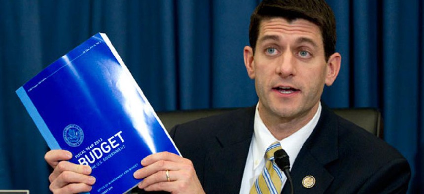 Rep. Paul Ryan, R-Wis., holds up Barack Obama's budget in February.