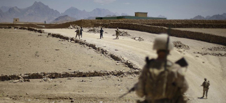 Afghan National police and U.S. Marines do a joint patrol through the town of Golestan in Afghanistan's Farah Province in 2009