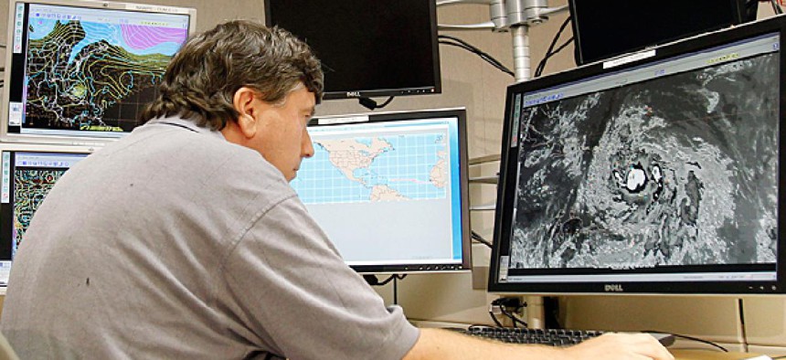 A senior hurricane specialist tracks Tropical Storm Isaac at the National Hurricane Center in Miami.