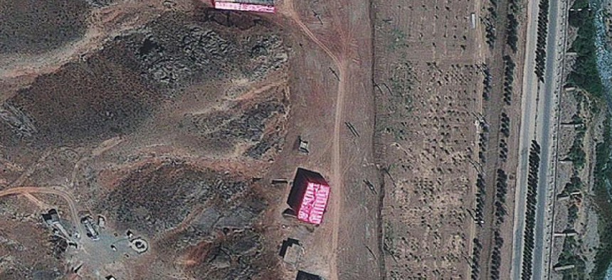 Analysts say te Parchin military complex is being shrouded with a pink tarp to stop the U.N nuclear agency from monitoring Tehran's efforts to develop a weapon.