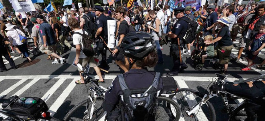 Police observe protestors Monday in Charlotte.
