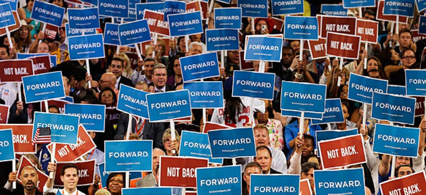 Delegates hold up signs at the Democratic National Convention in Charlotte, NC.