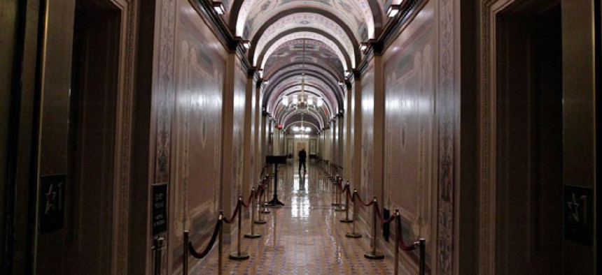 A worker walks the corridors of the United States Capitol.