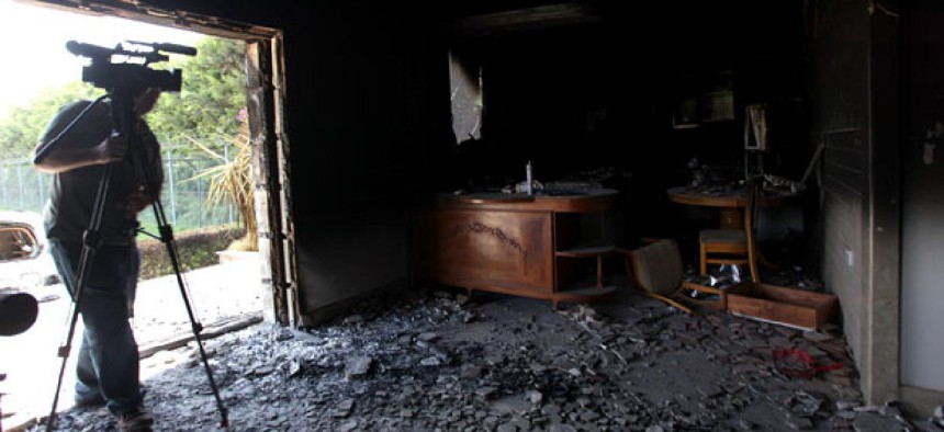 A man films the interior of the United States Consulate in Benghazi, Libya after an attack killed embassy workers.