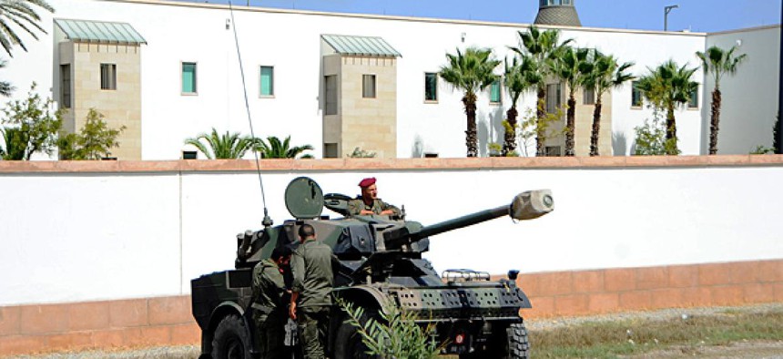 Tunisian police and army vehicles surround the U.S. Embassy in Tunisia.