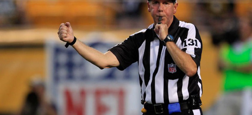NFL replacement referee Jim Winterberg makes a call in a preseason game.