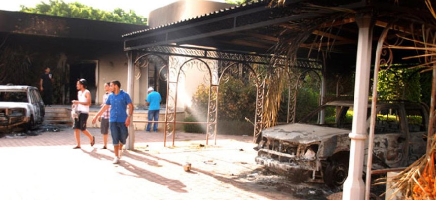 Libyans walk the grounds of the burned U.S. Consulate in Benghazi last month.