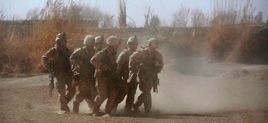 Marines carry a colleague wounded by an IED in Afghanistan in 2011.