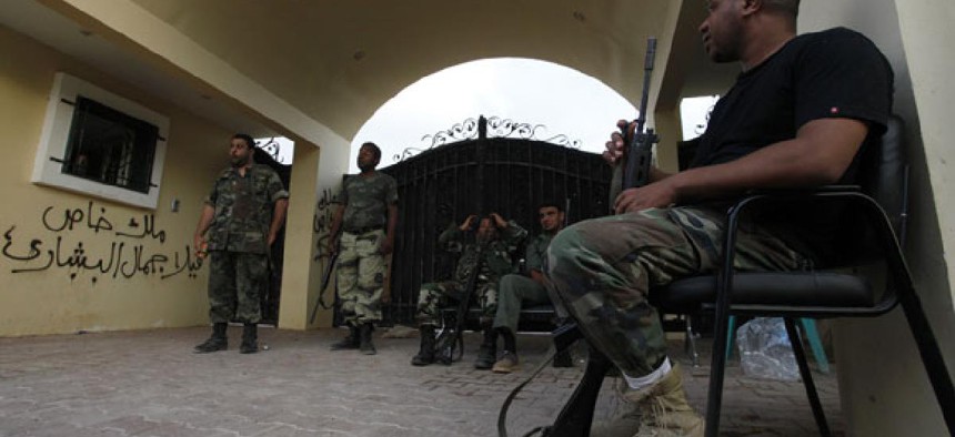 Security personnel stand guard outside the U.S. Consulate  in Benghazi in September.