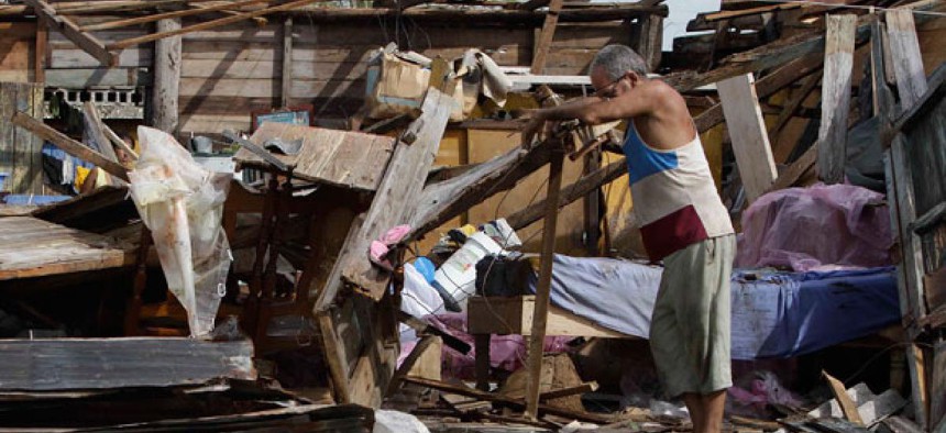Resident Antonio Garces tries to recover his belongings from his house destroyed by Hurricane Sandy in Aguacate, Cuba, Thursday Oct. 25, 2012. Hurricane Sandy blasted across eastern Cuba on Thursday as a potent Category 2 storm and headed for the Bahamas 