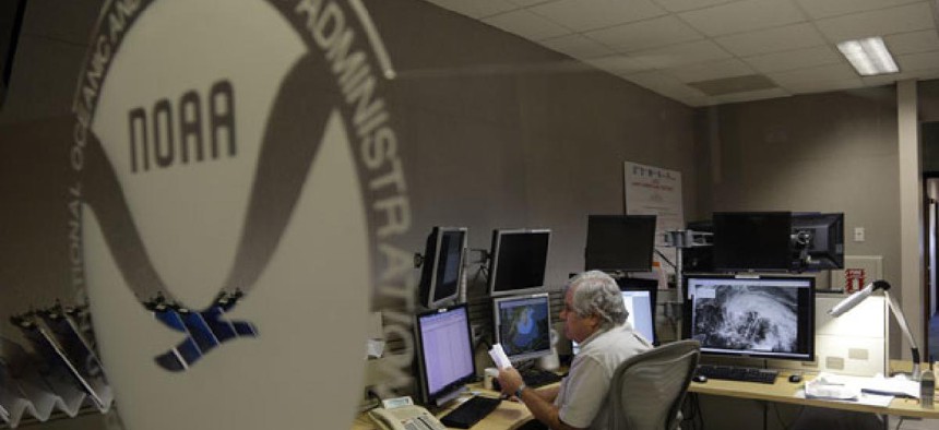 National Hurricane Center workers monitor the storm Friday.