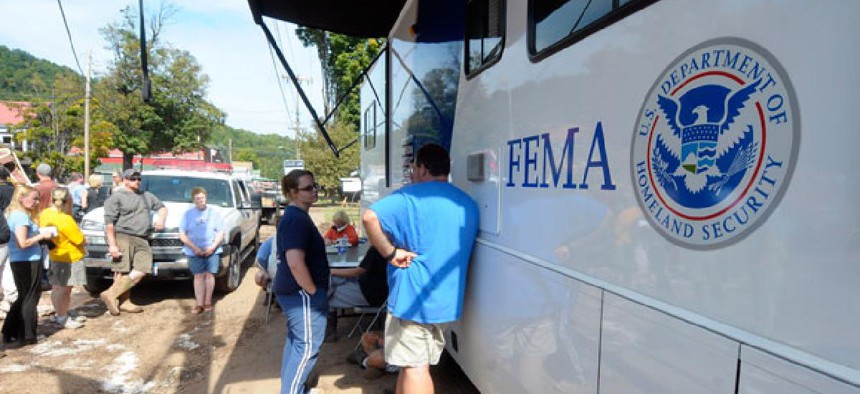 Flood victims line up to a FEMA trailer to get assistance in 2011.