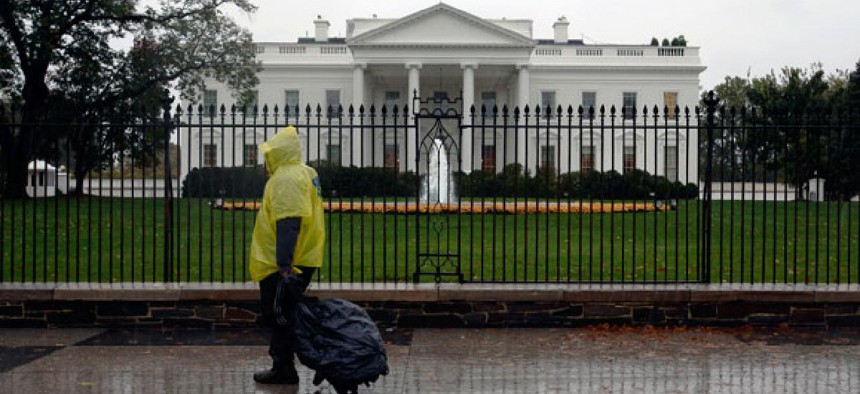 A lone pedestrian walks by the White House Monday afternoon as the storm hit.