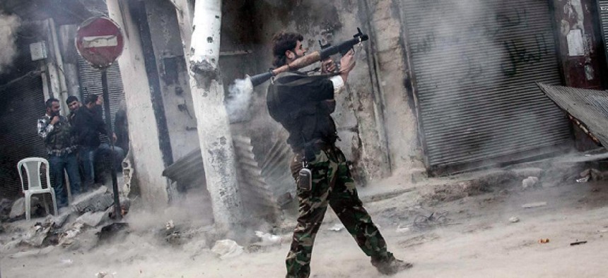 Nov. 04, 2012, a rebel fighter aims a missile toward a building where Syrian troops are hiding.