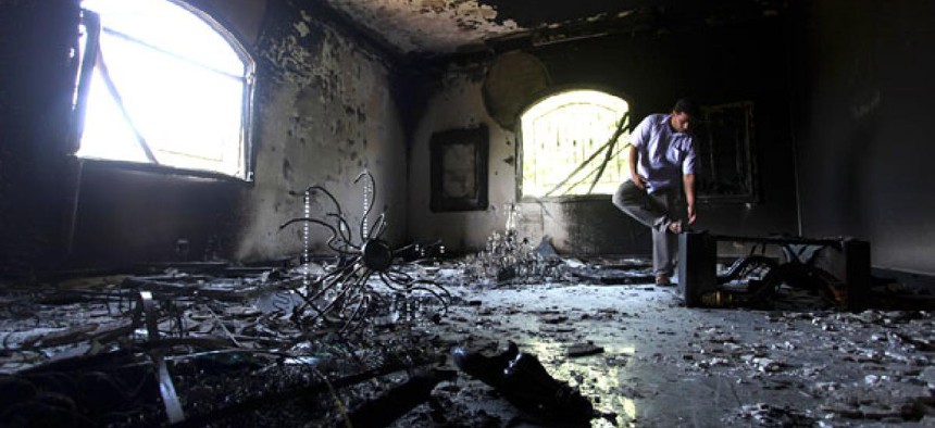 A Libyan man investigates the U.S. Consulate in Benghazi after it was attacked last month.