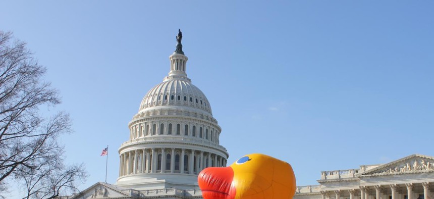 The Capitol grounds had a temporary lawn ornament Wednesday as Oxfam America activists dressed as Senate and House leaders and danced around a giant, inflatable duck to ask the lame duck session of Congress to protect foreign aid programs. 