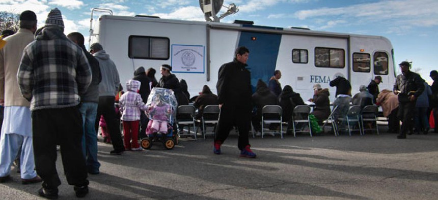 New Yorkers wait for assistance from a FEMA trailer on Coney Island after Sandy hit the area.