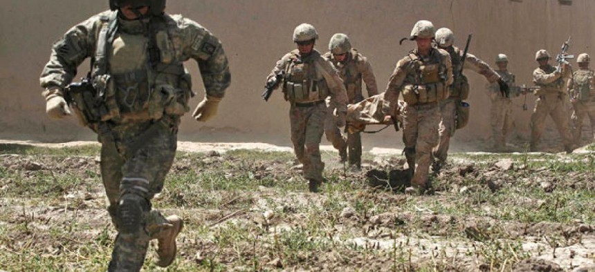 Marines rush a wounded colleague, who was shot during an exchange of fire with insurgents in Afghanistan, to a waiting medevac helicopter in 2011.