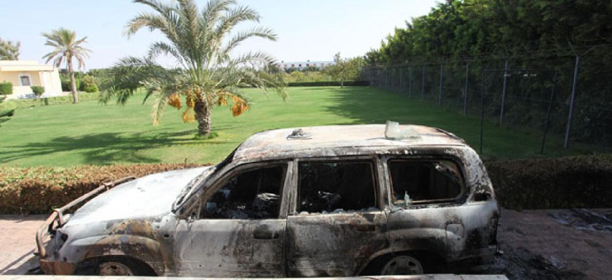A burnt car is parked in front of U.S. consulate in Benghazi after the attack in September.