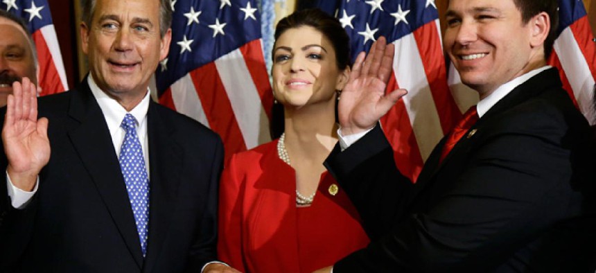 House Speaker John Boehner of Ohio performs a mock swearing in for Rep. Ron DeSantis, R-Fla.