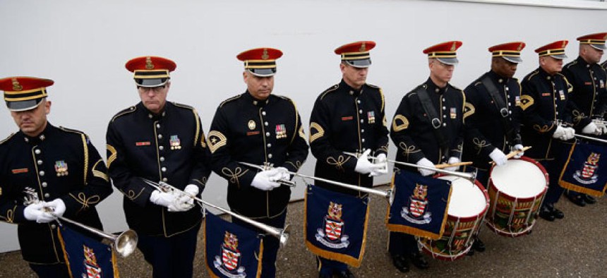 Members of the Army Band stand in front of the Presidential Reviewing Stand in front of the White House during a rehearsal Jan. 13, 2013.