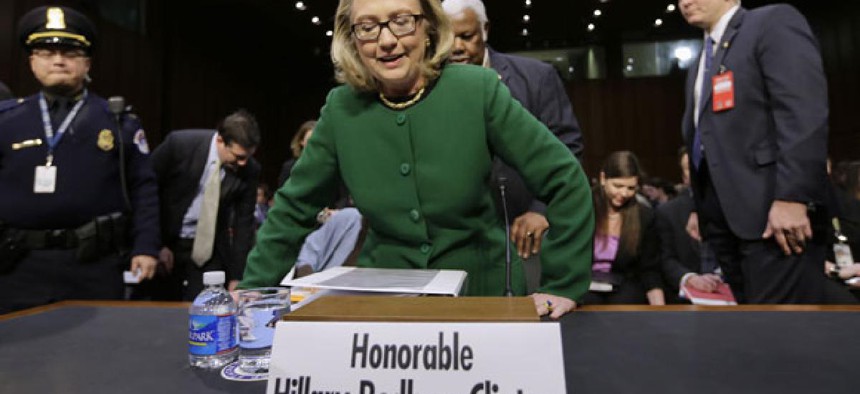 Secretary of State Hillary Clinton gets ready to testify Wednesday on Capitol Hill.