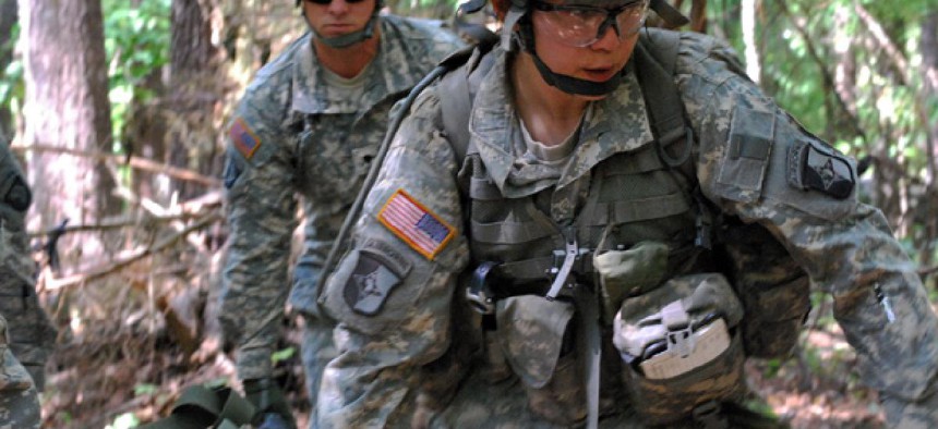 Capt. Sara Rodriguez, 26, of the 101st Airborne Division, carries a litter of sandbags during the Expert Field Medical Badge training at Fort Campbell, Ky.