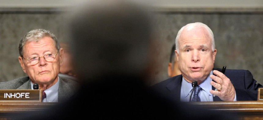 Sen. John McCain, R-Ariz., right, asks a question of former Nebraska Sen. Chuck Hagel.