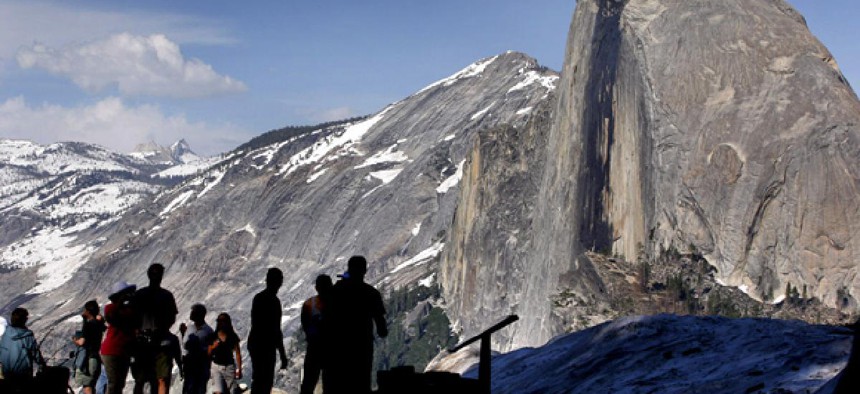 Visitors view Half Dome from Glacier Point at Yosemite National Park, Calif.