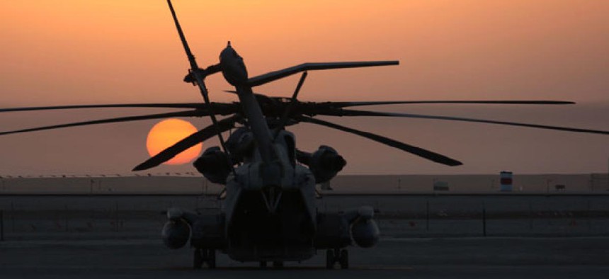 The sun rises over a CH-53E Super Stallion in Afghanistan in 2010