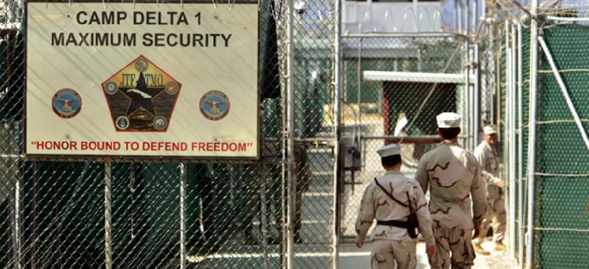 US military guards walk within Camp Delta military-run prison, at the Guantanamo Bay US Naval Base.