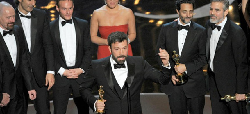Director/producer Ben Affleck, center, accepts the Academey Award for best picture for "Argo."