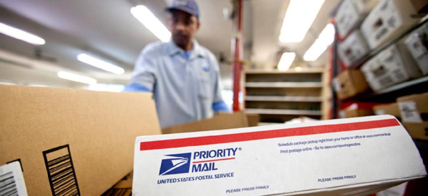 Packages wait to be sorted in a Post Office as U.S. Postal Service letter carrier of 19 years, Michael McDonald, gathers mail to load into his truck before making his delivery run. 