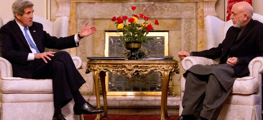 Secretary of State John Kerry meets with Afghan President Hamid Karzai at the Presidential Palace in Kabul.