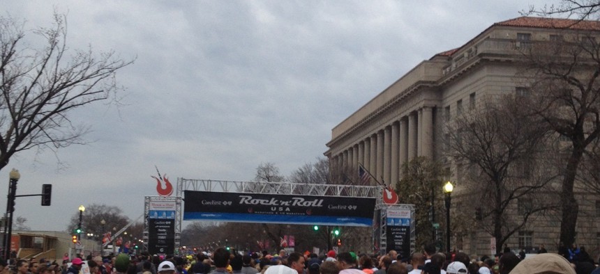 The Rock N' Roll Marathon gets underway the morning of March 16 under threatening skies on Constitution Ave in Washington, D.C. The Department of Commerce building is at right. 