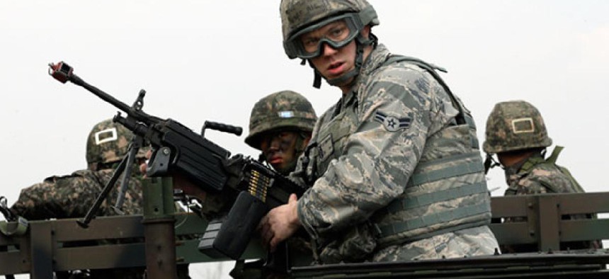 U.S. Air Force Airman First Class, Lee Simpson mans a machine gun atop a humvee, with South Korean soldiers during a joint military drill between South Korea and the United States near Seoul. 
