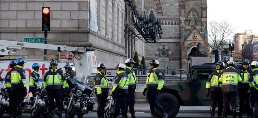 Boston police officers keep a perimeter secure in Boston's Copley Square Tuesday morning.