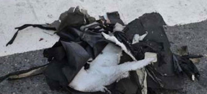 The remains of a black backpack sit on a Boston street that the FBI says contained one of the bombs that exploded during the Boston Marathon Tuesday. 