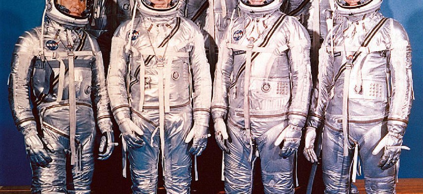The Project Mercury Astronauts. They are: front row, left to right, Walter H. Schirra, Jr., Donald K. Slayton, John H. Glenn, Jr., and Scott Carpenter; back row, Alan B. Shepard, Jr., Virgil I. Gus Grissom, and L. Gordon Cooper.