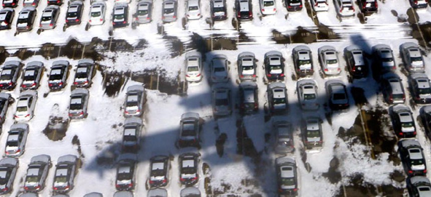 Continental Airlines flight 3306 from Toronto casts a shadow over a snow covered parking lot as it approaches Newark airport in Newark, New Jersey.