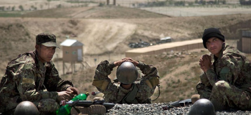Afghan Army soldiers rest between training sessions at a military training facility on the outskirts of Kabul, Afghanistan. 