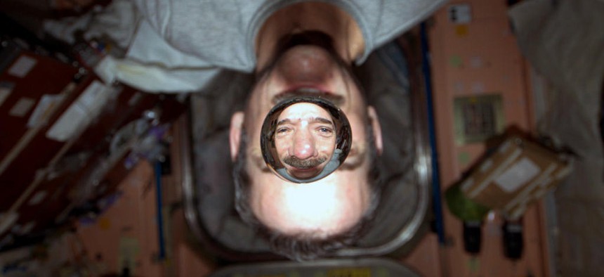 Chris Hadfield experiments with water drops in microgravity