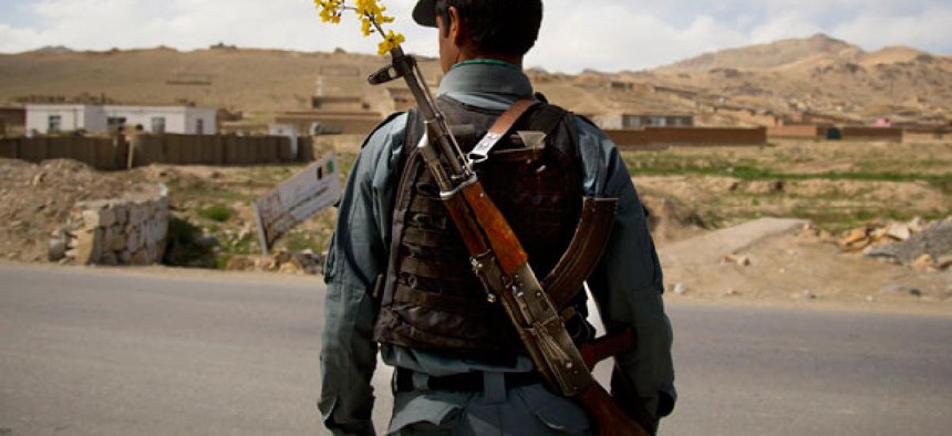 An Afghan National Police officer watches over a checkpoint